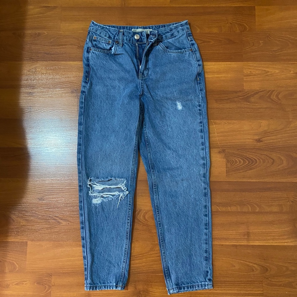 Blue Topshop jeans with one knee rip